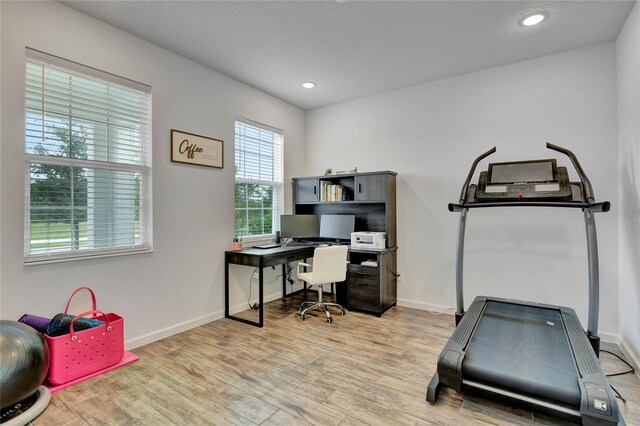 home office featuring a textured ceiling and light wood-type flooring