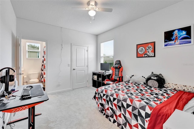 carpeted bedroom with ceiling fan, ensuite bathroom, and a textured ceiling