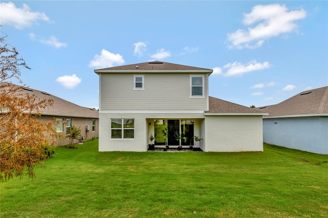 rear view of property with a lawn and a patio area