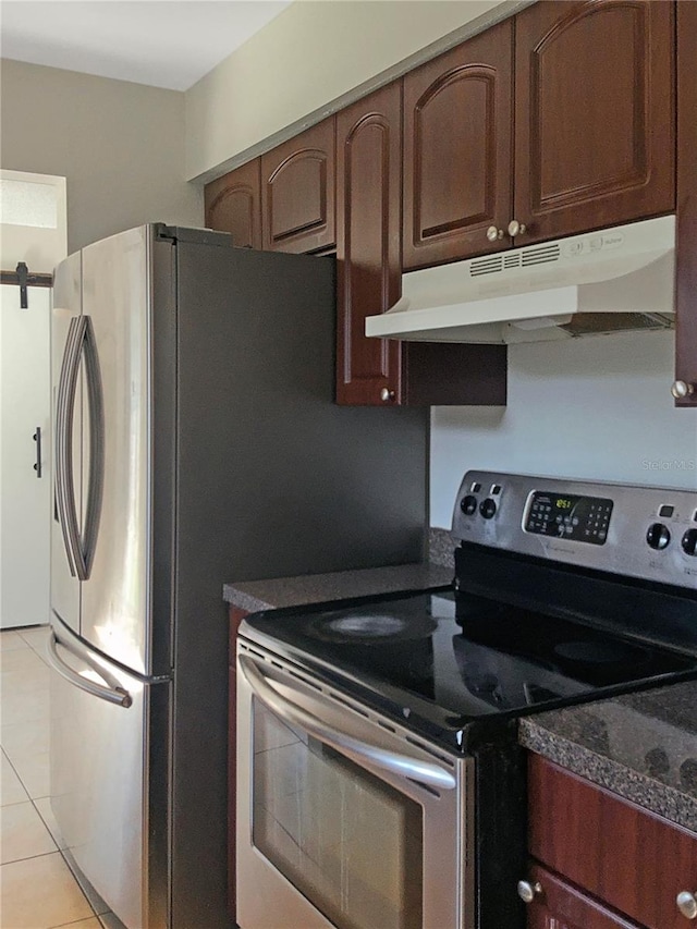 kitchen with electric range and light tile patterned flooring