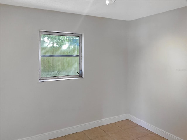 unfurnished room featuring light tile patterned floors