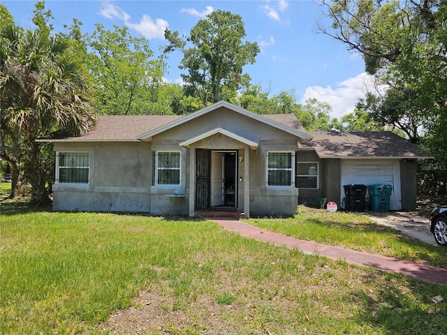 ranch-style house with a garage and a front lawn