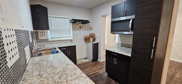 kitchen featuring sink, backsplash, and dark hardwood / wood-style floors