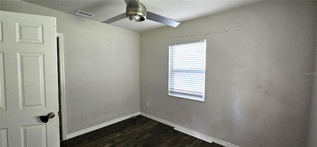 spare room with dark hardwood / wood-style flooring and ceiling fan