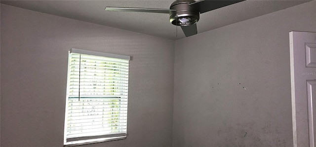 interior space with ceiling fan