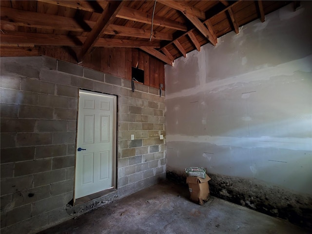 misc room featuring lofted ceiling and concrete floors