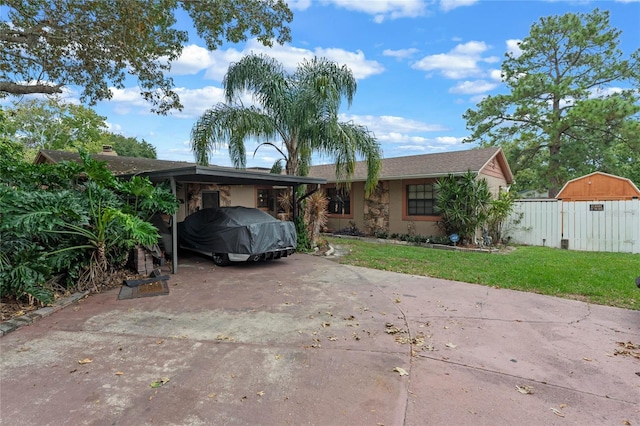 ranch-style house featuring a carport and a front lawn