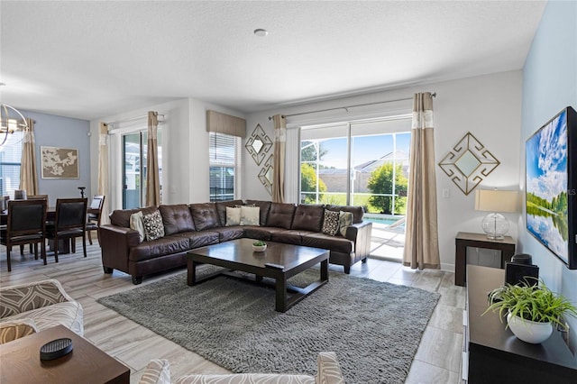 living room featuring a notable chandelier and a textured ceiling