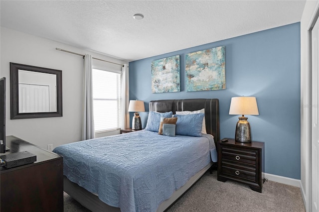 carpeted bedroom with a textured ceiling