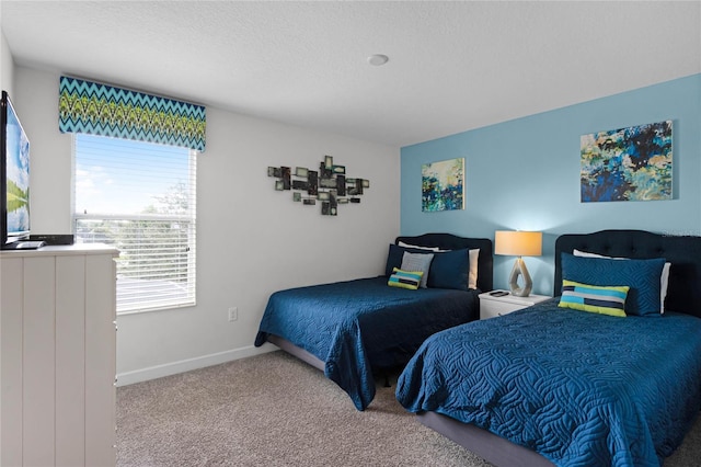 bedroom with carpet floors and multiple windows