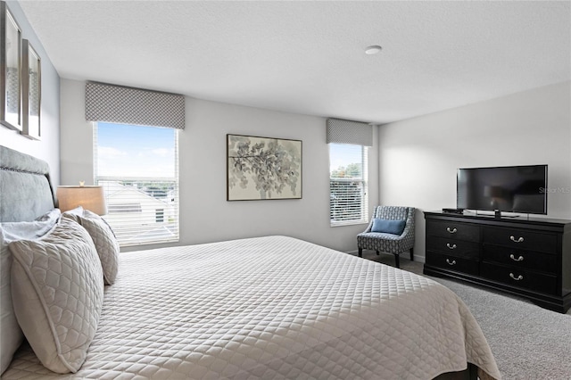 carpeted bedroom featuring a textured ceiling