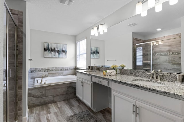 bathroom featuring hardwood / wood-style flooring, separate shower and tub, and vanity