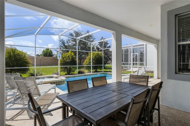 view of patio / terrace featuring glass enclosure and a pool with hot tub