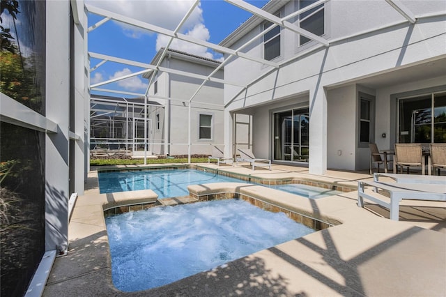 view of swimming pool featuring an in ground hot tub, a patio area, and glass enclosure