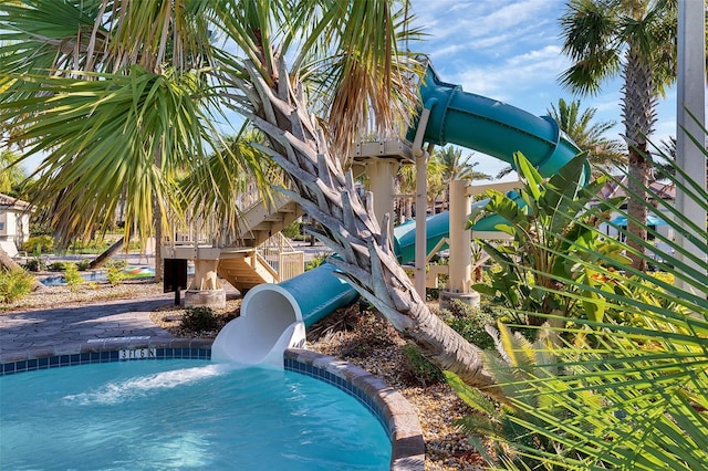 view of swimming pool with a water slide