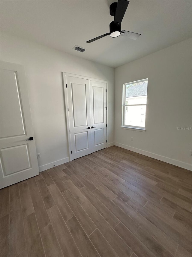 unfurnished bedroom featuring light wood-type flooring and ceiling fan