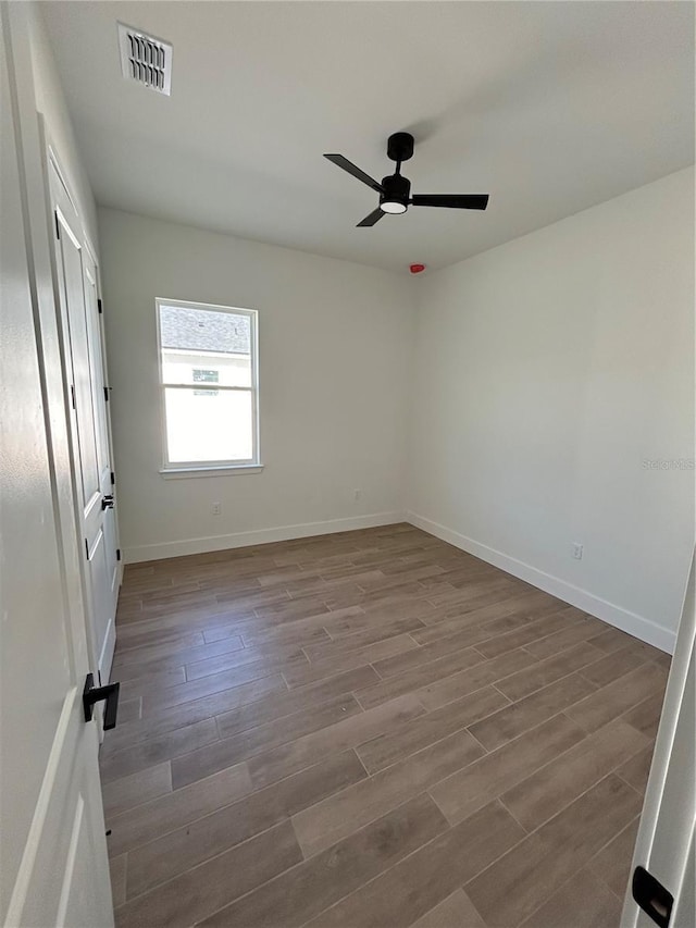 spare room featuring hardwood / wood-style flooring and ceiling fan