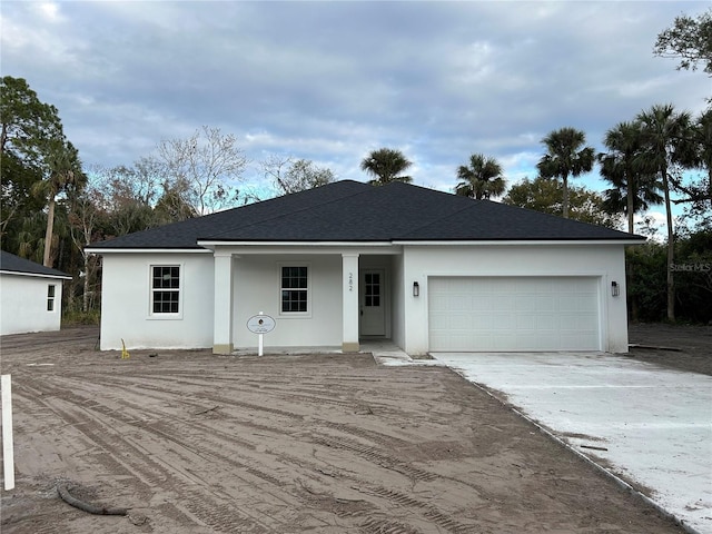 ranch-style home featuring a garage