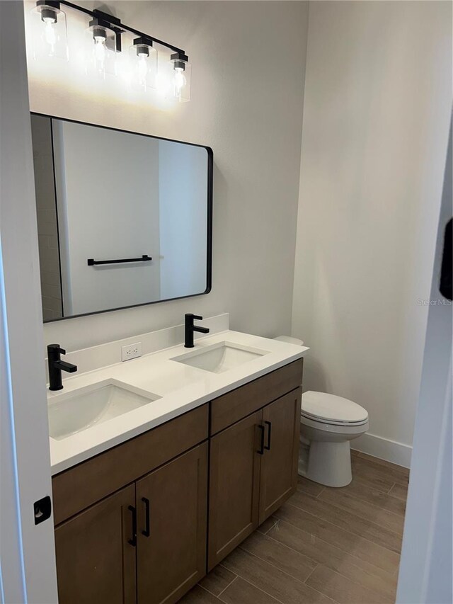 bathroom featuring vanity and toilet