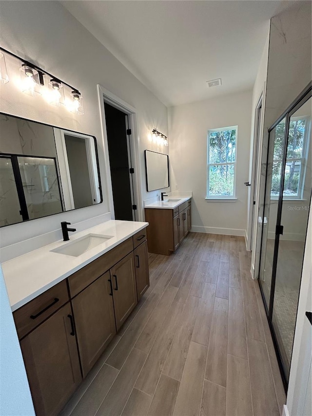 bathroom featuring vanity, hardwood / wood-style floors, and walk in shower