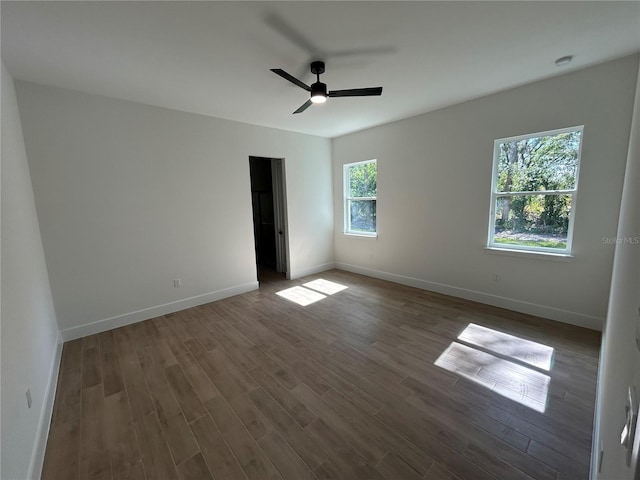 unfurnished room featuring dark hardwood / wood-style floors and ceiling fan