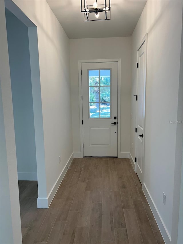 entryway featuring an inviting chandelier and hardwood / wood-style floors