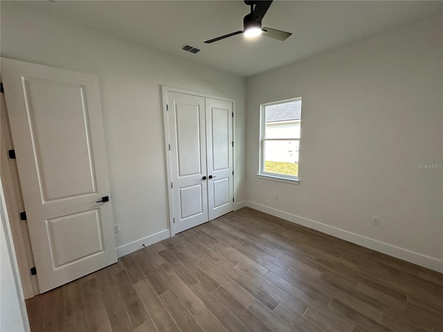 unfurnished bedroom with ceiling fan, a closet, and light wood-type flooring