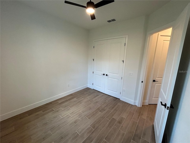 unfurnished bedroom with a closet, ceiling fan, and light wood-type flooring