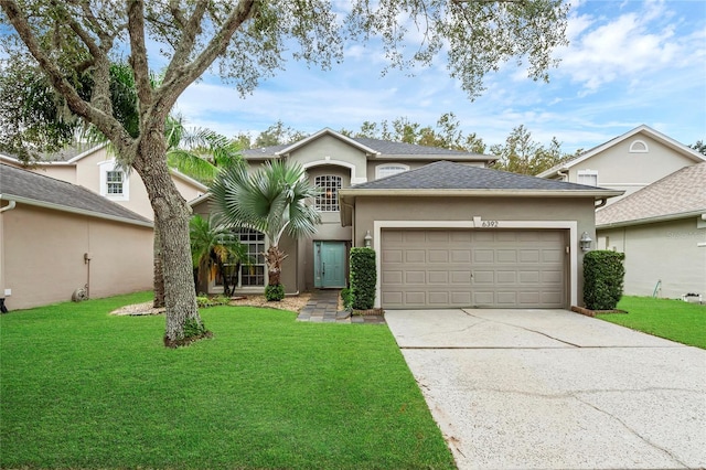 view of front of home with a front yard and a garage