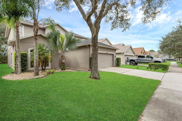 view of front of home featuring a front lawn and a garage