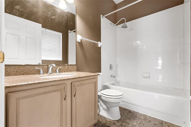 full bathroom featuring vanity, toilet, and tiled shower / bath combo