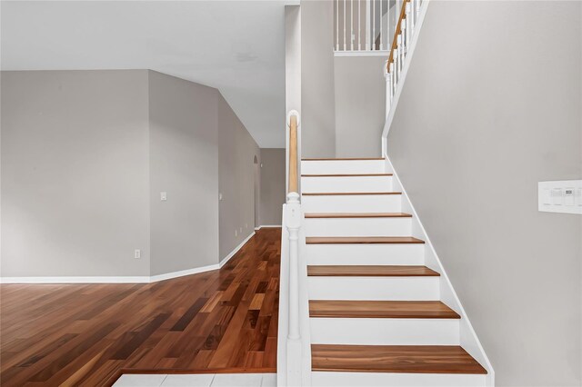 stairs featuring wood-type flooring