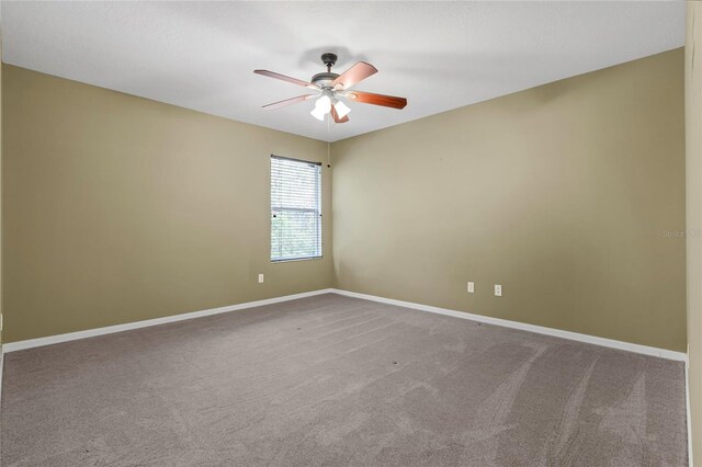 unfurnished room with carpet flooring and ceiling fan