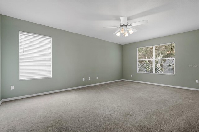 spare room featuring ceiling fan and carpet flooring