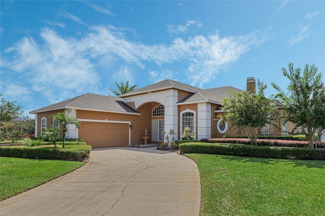 view of front of house with a garage and a front yard