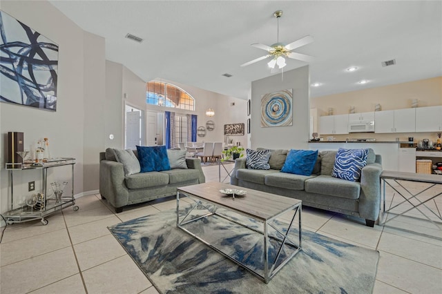 living room with ceiling fan and light tile patterned floors