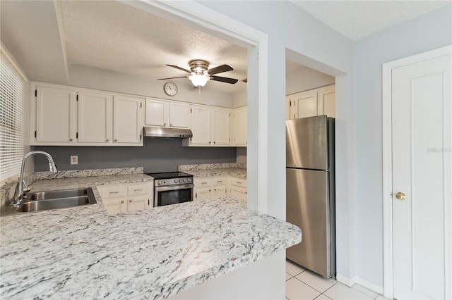 kitchen featuring a textured ceiling, light tile patterned flooring, sink, appliances with stainless steel finishes, and ceiling fan