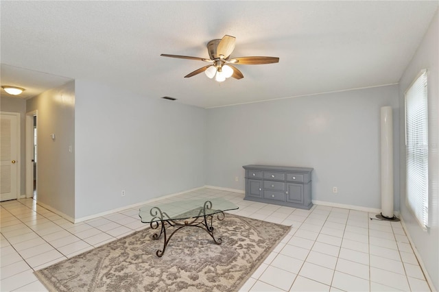 sitting room with ceiling fan and light tile patterned floors