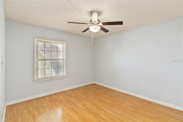 spare room featuring ceiling fan and light hardwood / wood-style flooring