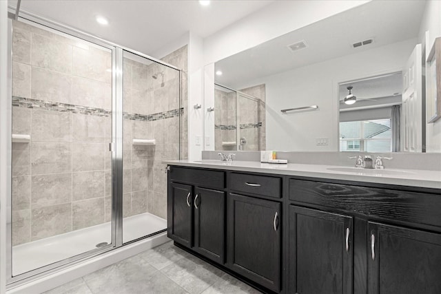 bathroom featuring vanity, ceiling fan, and a shower with door