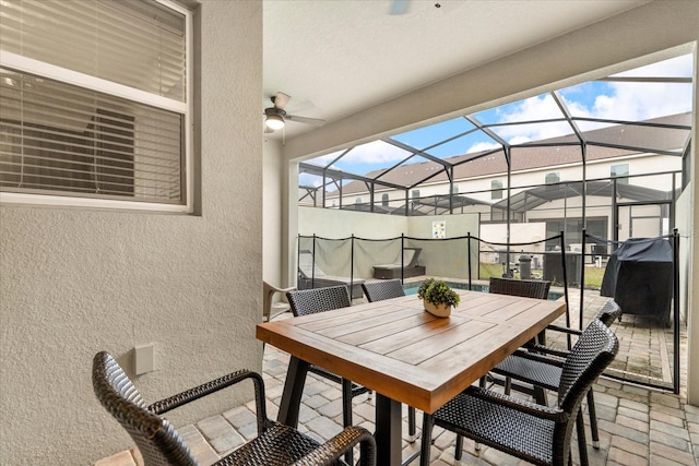 view of patio / terrace with ceiling fan and a lanai