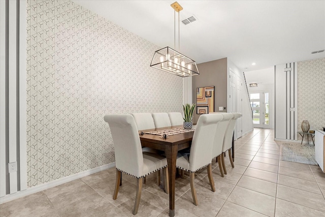 dining area featuring light tile patterned floors and an inviting chandelier