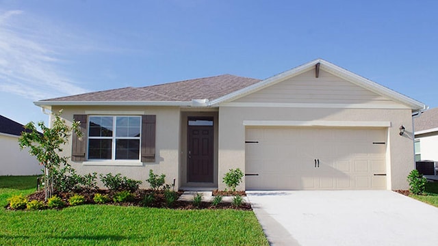 ranch-style house with a front yard, a garage, and central AC unit