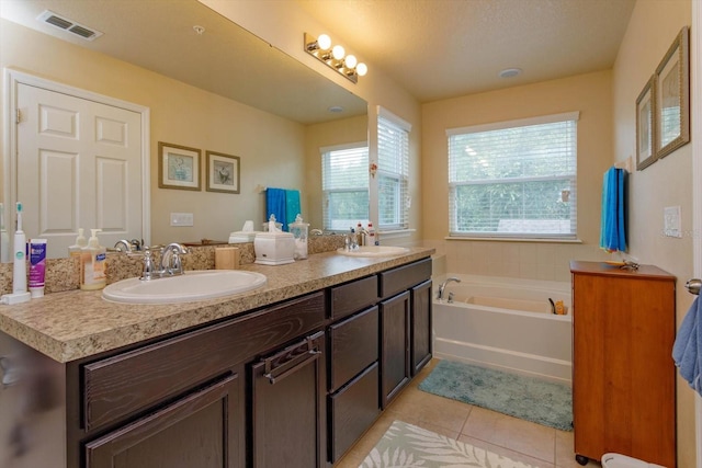 bathroom featuring vanity, a bathing tub, and tile patterned flooring