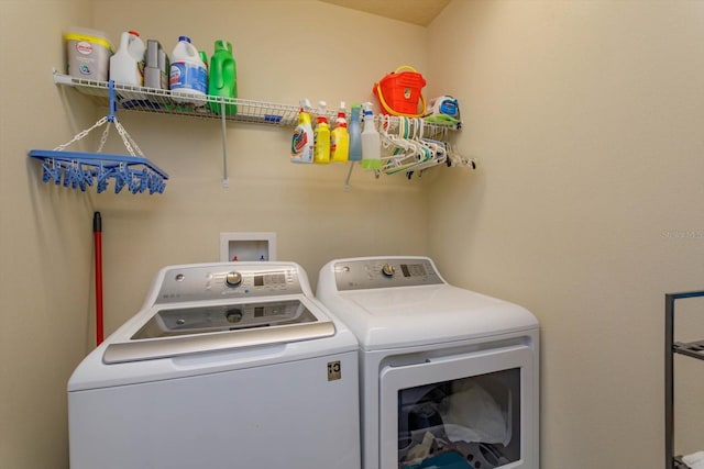 clothes washing area with washer and dryer