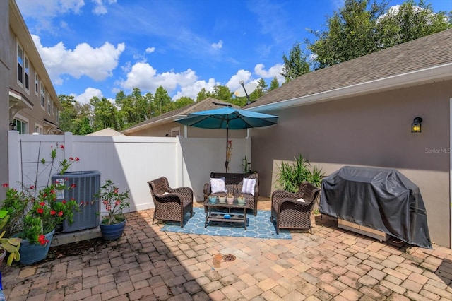 view of patio featuring outdoor lounge area, cooling unit, and grilling area