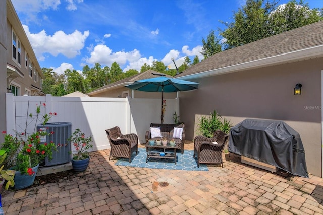 view of patio featuring an outdoor hangout area, central AC unit, fence, and area for grilling