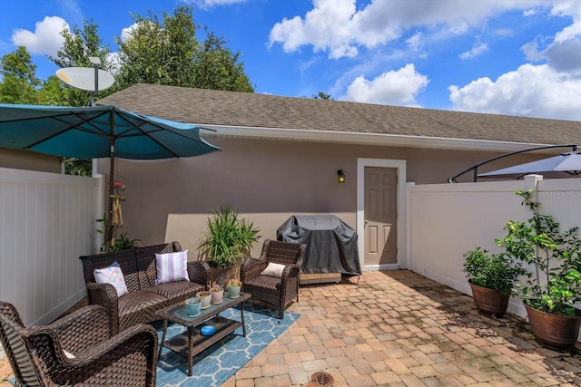 view of patio with an outdoor living space and a grill