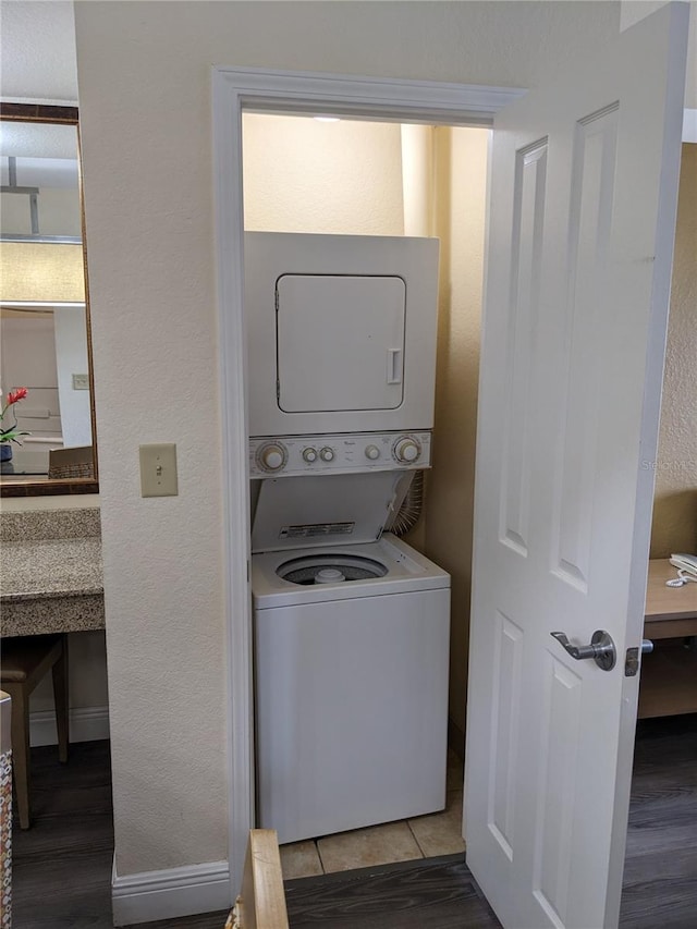 12527 Floridays Resort Dr Unit 510E, Orlando, FL 32821 - laundry room featuring stacked washer and dryer and hardwood / wood-style floors