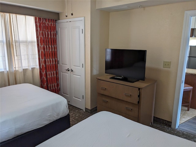 12527 Floridays Resort Dr Unit 510E, Orlando, FL 32821 - bedroom featuring dark hardwood / wood-style flooring and a closet